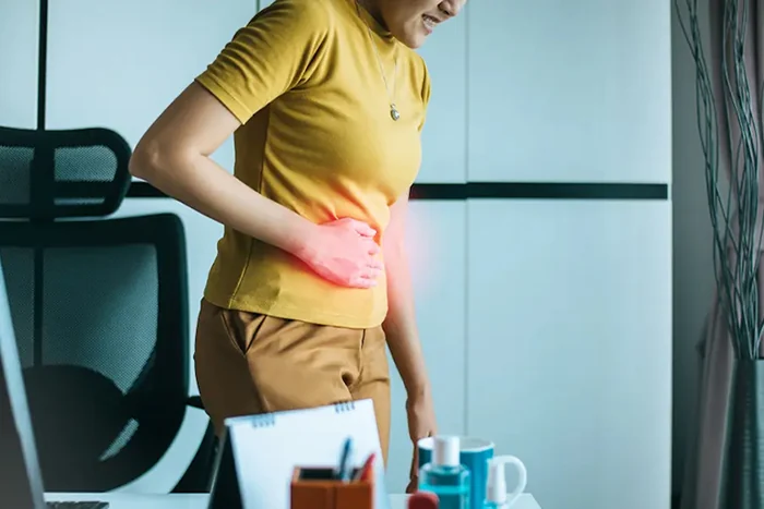 woman touching abdomen in pain