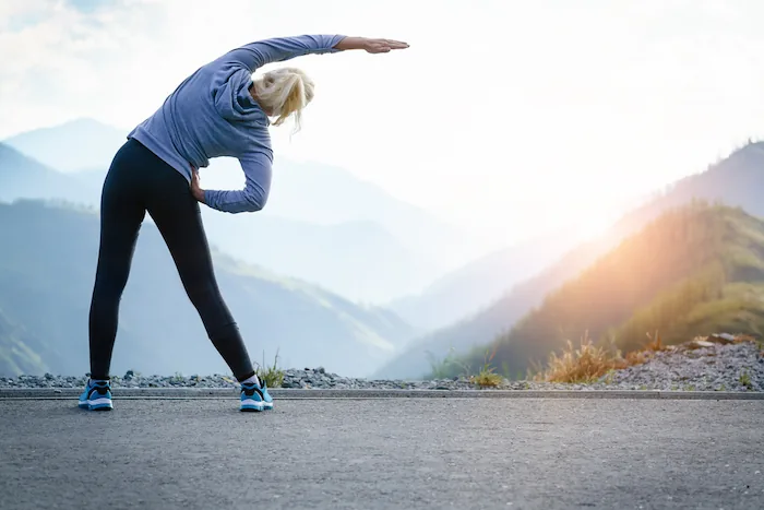 healthy woman outdoors stretching
