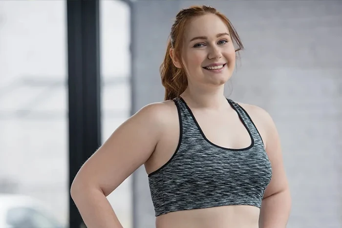 happy woman exercising in gym