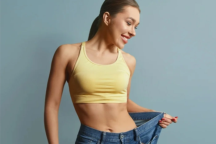 confident woman in large size jeans after weight loss