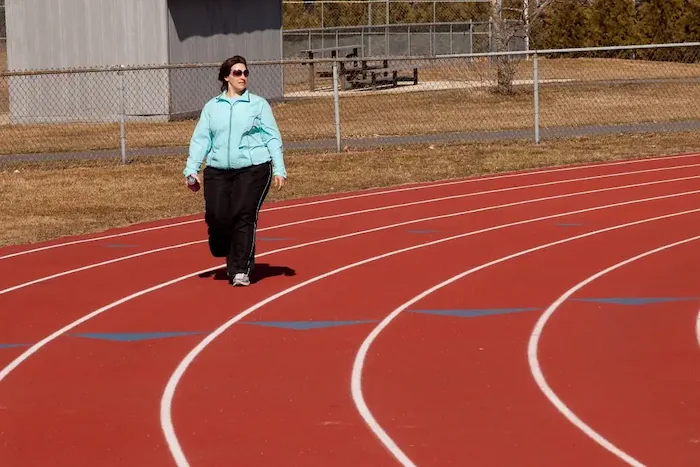 woman walking on track
