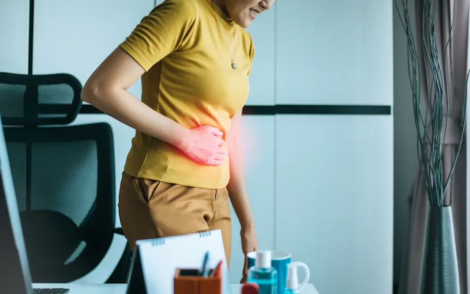 woman touching abdomen in pain