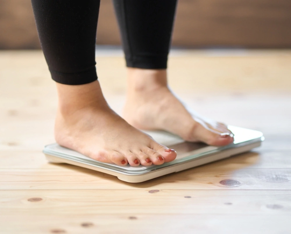 woman stepping on scale