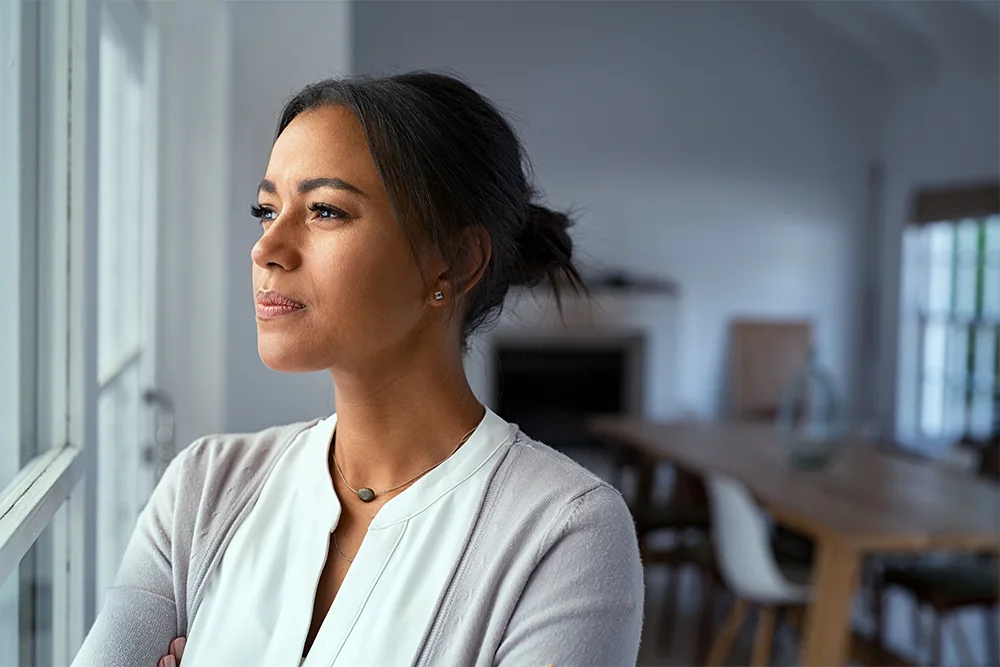 pensive woman looking out the window