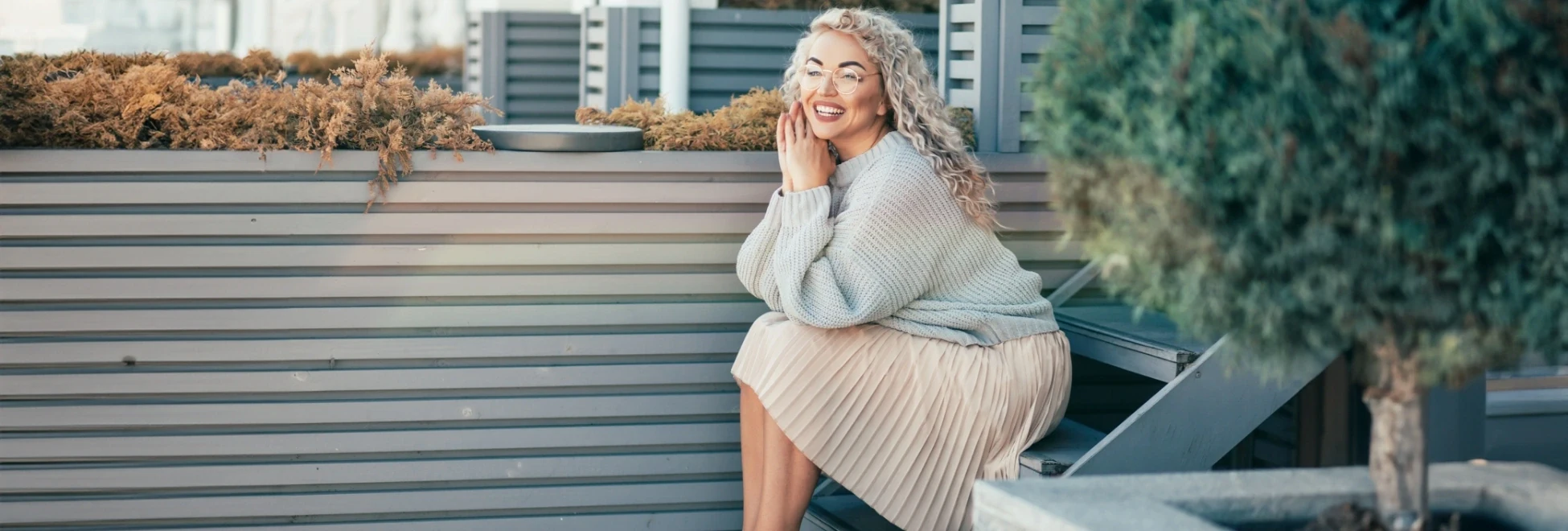 happy woman sitting on stairs