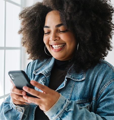 happy plus size woman making payment through her smartphone