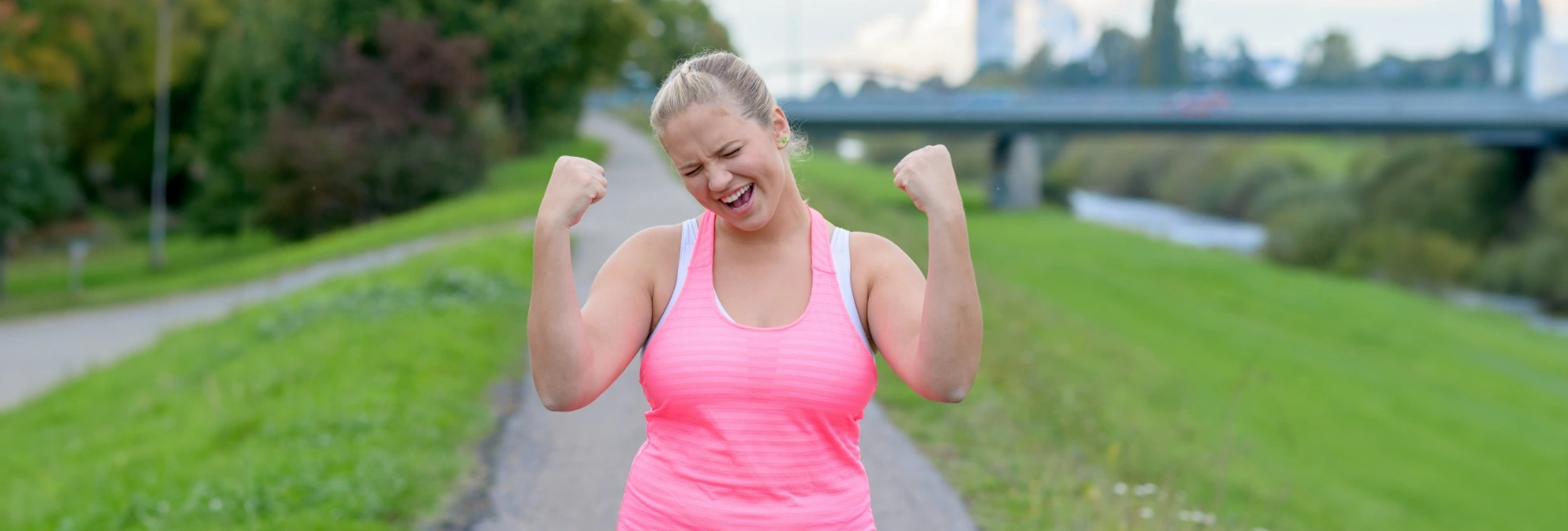 woman exercising and showing excitement about her success
