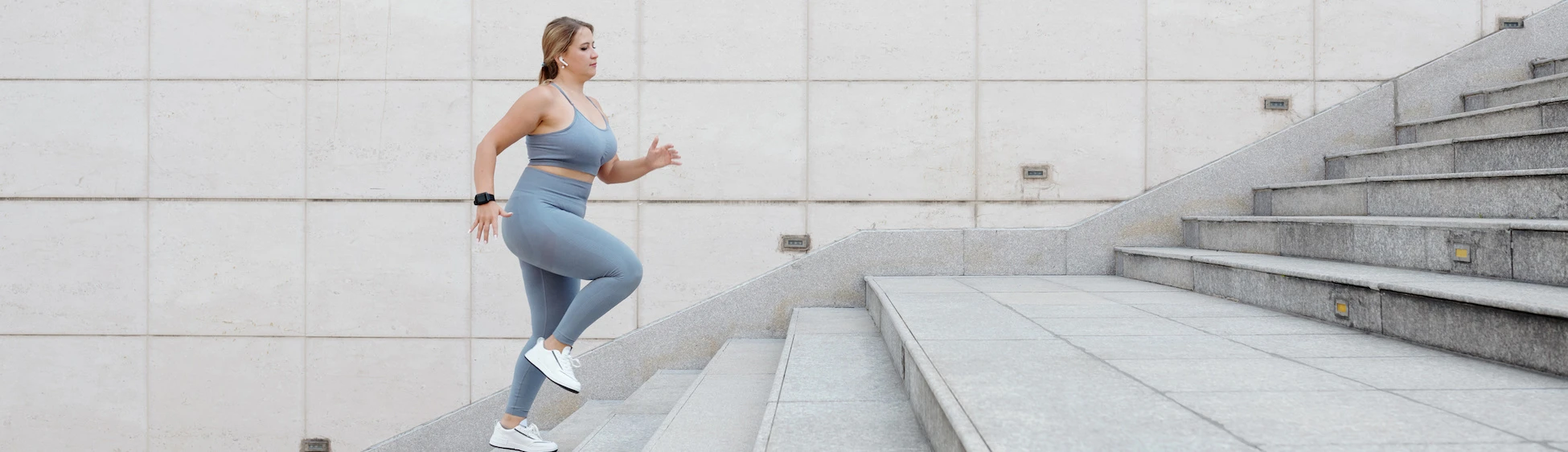 plus size woman exercising running up stairs