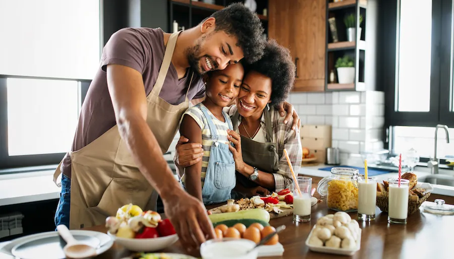 family in the kitchen cooking together happily