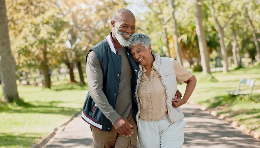 happy couple walking through the park during spring season